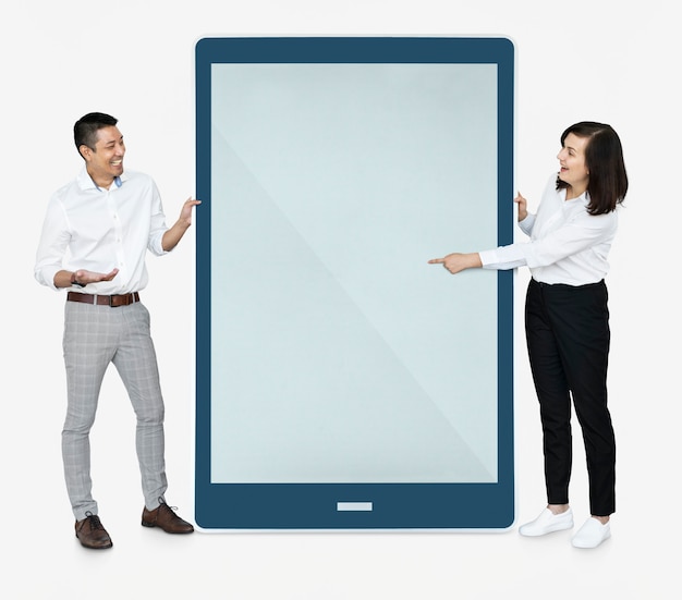 Cheerful people pointing at a tablet screen