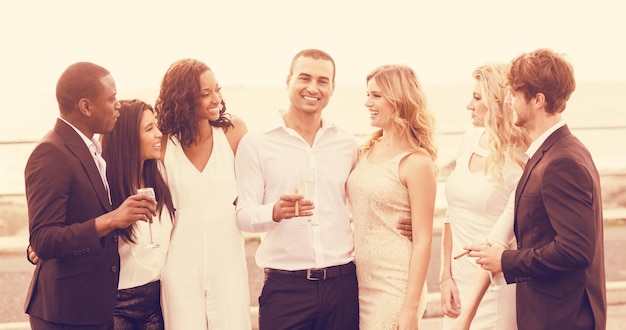 Photo cheerful people posing next to limousine on night out