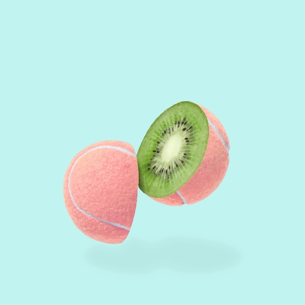 A cheerful pink tennis ball with a slit and a kiwi inside