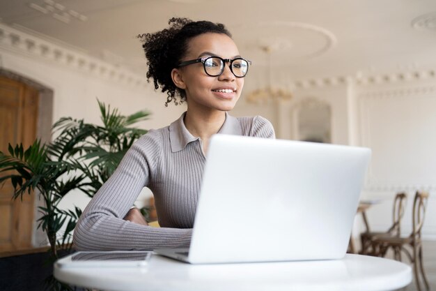 Photo cheerful professional woman with laptop enjoying a productive day in a classic interior