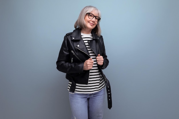 Cheerful s mature woman in a stylish jacket on a bright background