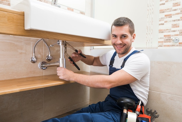 Cheerful sanitary technician at work