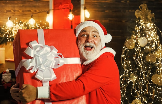 Cheerful santa claus with big present new year gift christmas decorations family holidays