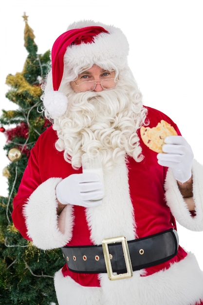 Cheerful santa eating a cookie