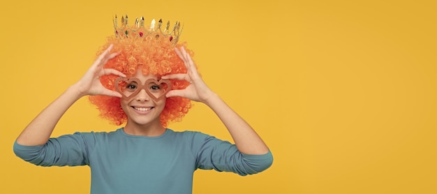 Cheerful selfish child girl in curly wig and princess diadem wear party glasses birthday funny teenager child in wig party poster banner header copy space