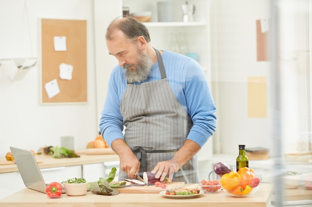 Cheerful Senior Chef in Kitchen