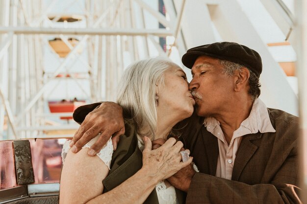 Photo cheerful senior couple enjoying a ferris wheel by the santa monica pier