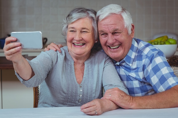 Cheerful senior couple taking selfie