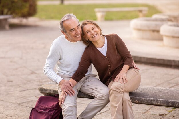 Cheerful Senior Husband And Wife Hugging Having Date In Park