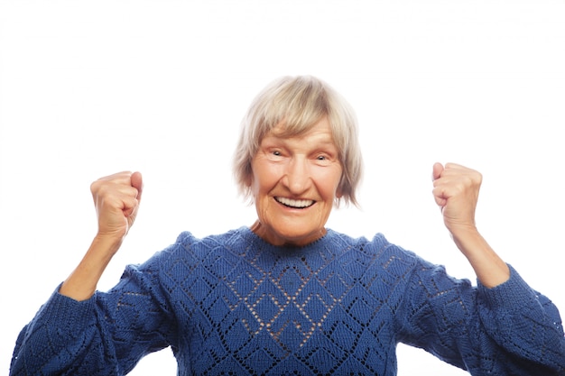 Cheerful senior woman gesturing victory