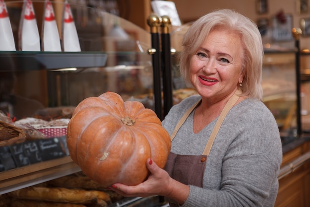 Cheerful senior woman wearing apron