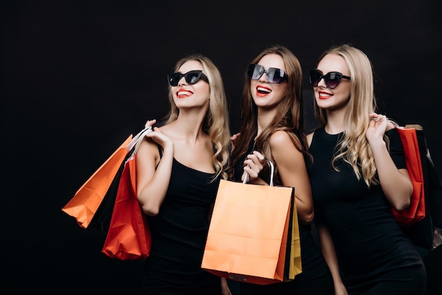 Cheerful Shopping Mate Girls in Black Dresses Posing