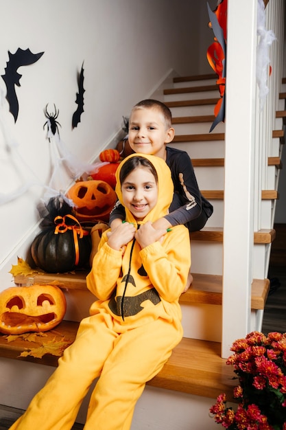 Cheerful siblings ready for halloween trick or treat