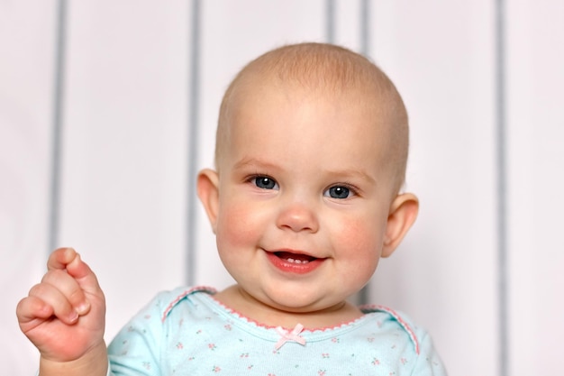 Cheerful smile of a little girl with three teeth. First teeth.