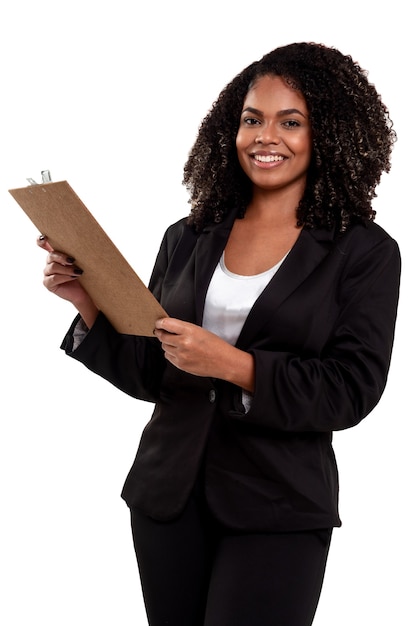 cheerful and smiling executive black brazilian woman isolated on white, working with a clipboard and holding a pen.