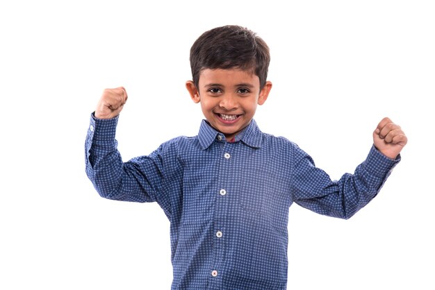 Cheerful smiling little boy raised his hands up. Isolated on white background.