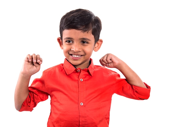 Cheerful smiling little boy raised his hands up. Isolated on white background.