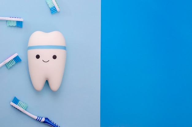 Cheerful smiling tooth on a blue