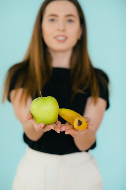 Cheerful smiling woman holding apple