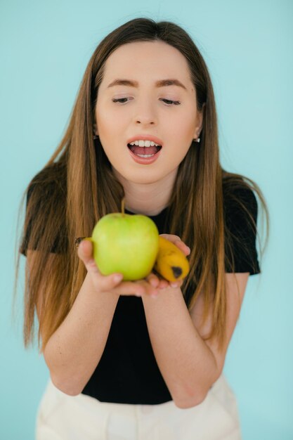 Cheerful smiling woman holding apple