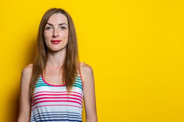 Cheerful smiling young woman in a striped dress 