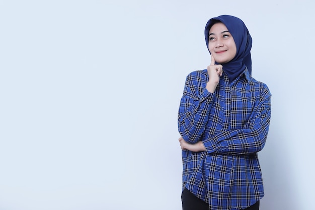 Cheerful and Smilling young female has positive expression has overjoyed look, being in high spirit, wearing hijab, isolated over white wall nice expression