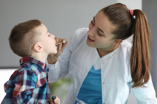 Cheerful specialist talking to kid