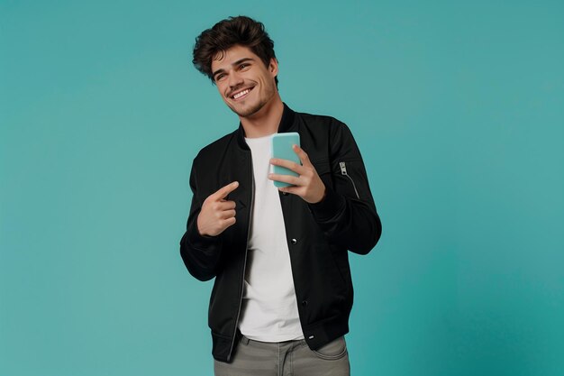 Cheerful sporty redhaired guy shows a finger on the smartphone screen on a blue background