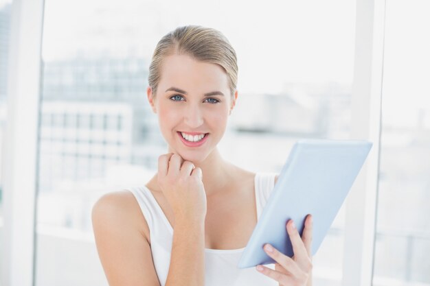 Cheerful sporty woman using tablet computer