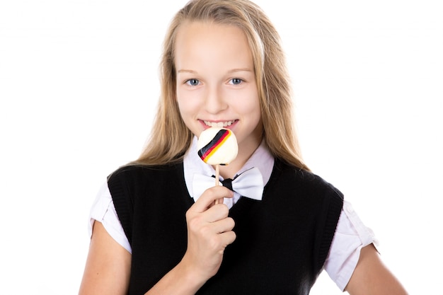 Cheerful student biting a lollipop