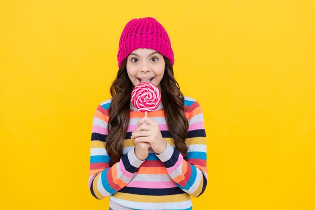 Cheerful teen girl eating lollipop candy dental health