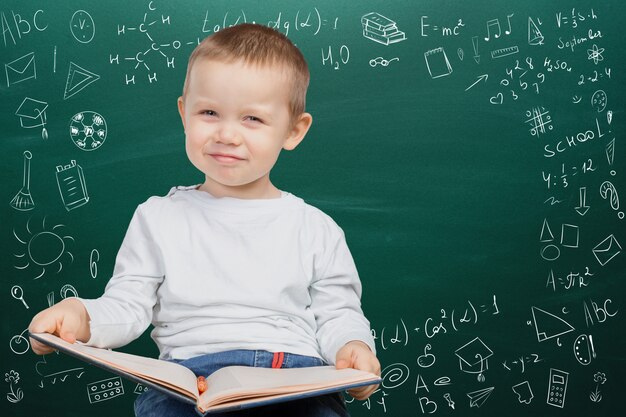 Cheerful thoughtful school boy, back to school concept