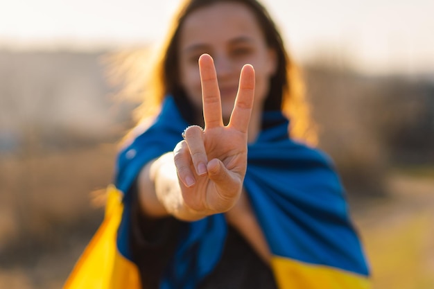 Cheerful ukrainian girl that shows a sign of peace or victory