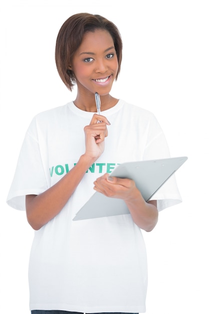 Cheerful volunteer woman holding clip board