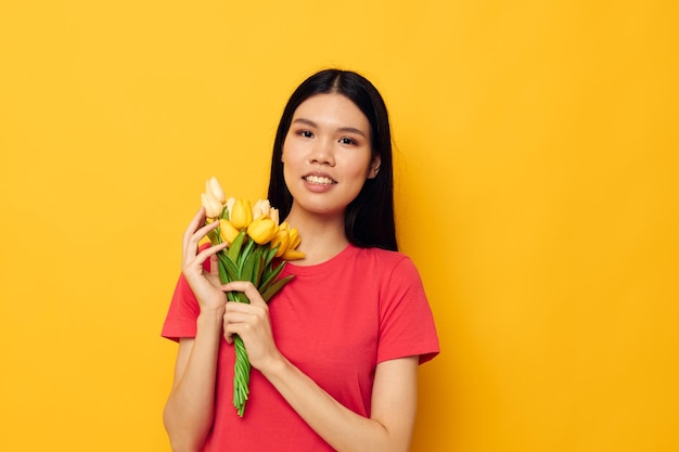 Cheerful woman of asian appearance bouquet of flowers spring