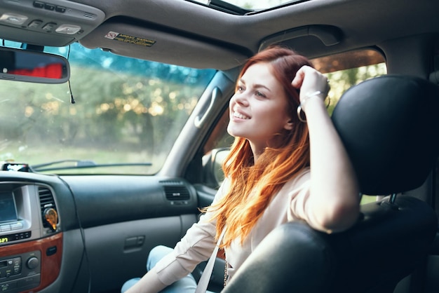 Cheerful woman in car trip journey road