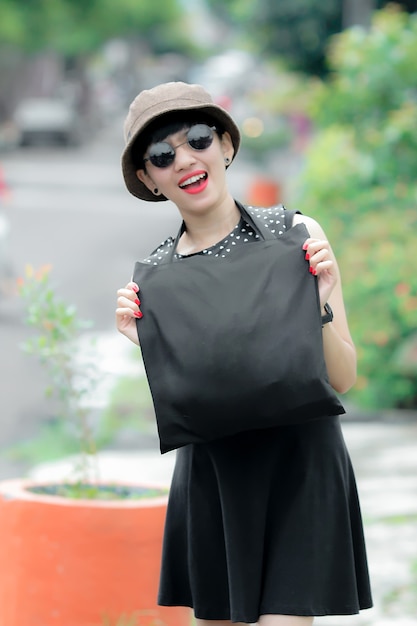 cheerful woman carrying black sling bag