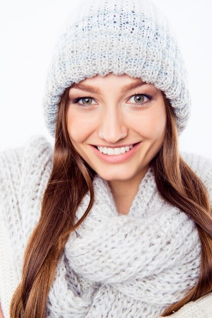 Cheerful woman clothing in warm hat and scarf, close up photo