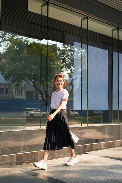 Cheerful woman doing shopping in a big city