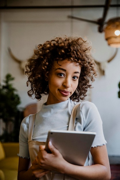 Cheerful woman holding a digital tablet in her arm