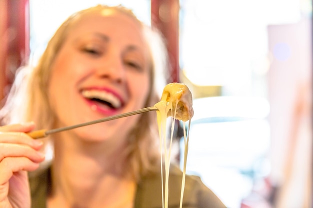 Cheerful woman holding food at restaurant