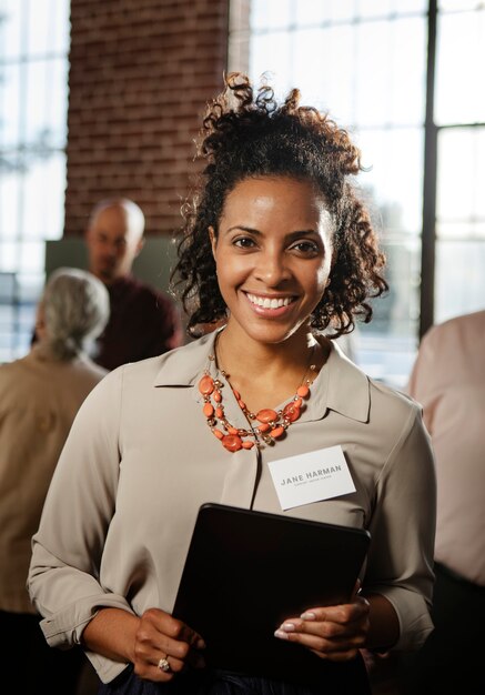 Cheerful woman holding her tablet