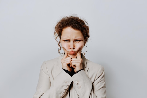 Cheerful woman In a light classic suit posing emotions light background unaltered