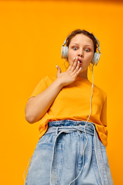 Cheerful woman listening to music on headphones youth style isolated backgrounds unaltered