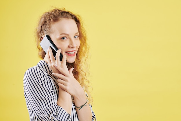 Cheerful woman making phone call