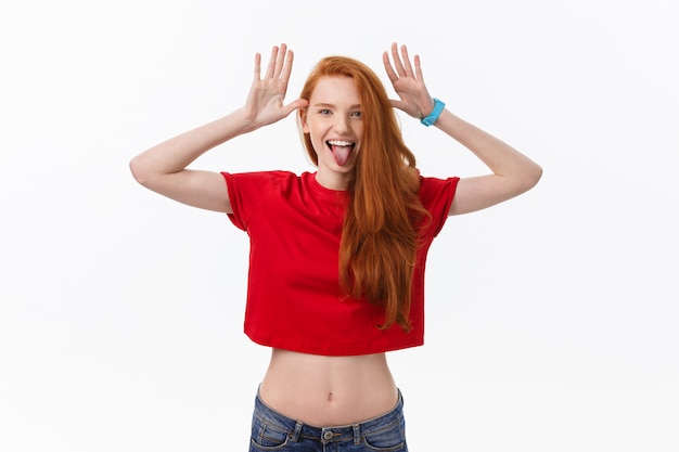 cheerful woman playing with hair smiling and laughing, posing over white