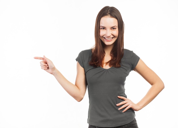 Cheerful woman pointing at copy space isolated on white