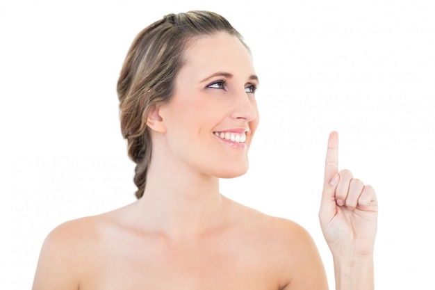 Cheerful woman pointing and looking up