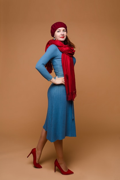 Cheerful woman poses, picture isolated on orange wall