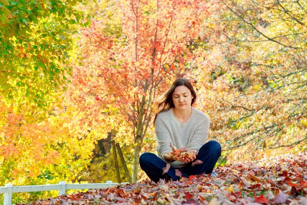 Cheerful woman relaxing in beautiful autumn day concept freedom